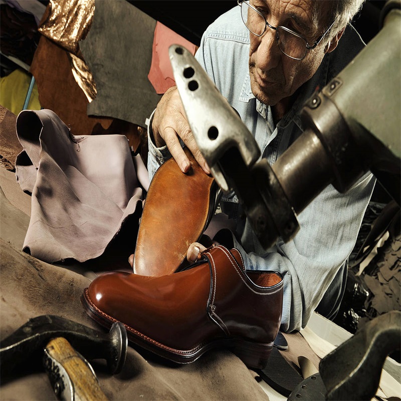 An Old man gluing shoe leather