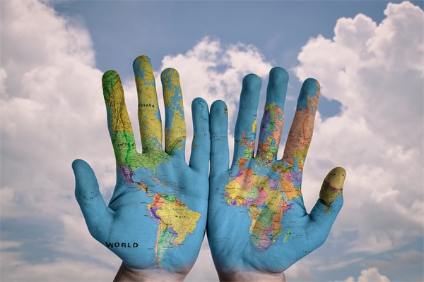 Blue Sky and White Clouds, Paint the Shape and Color of the World Map on the Hands