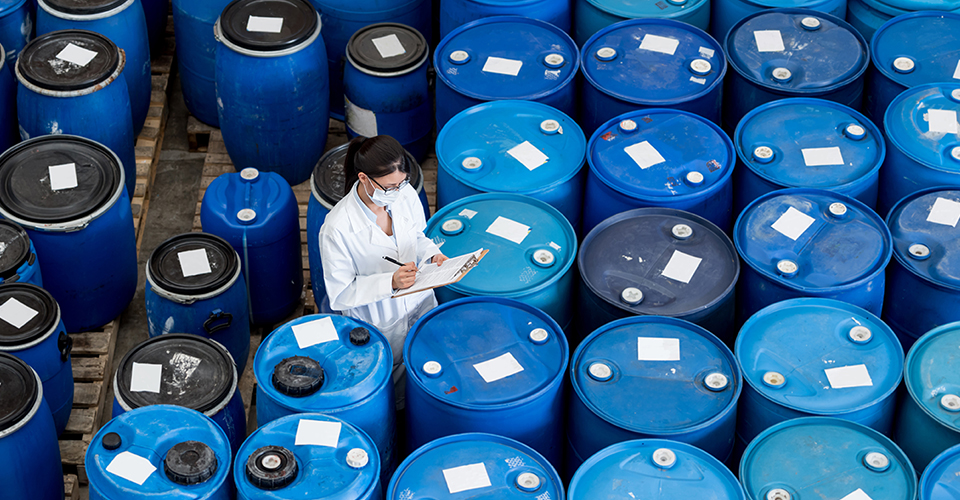 Lots of blue emulsion buckets, a woman